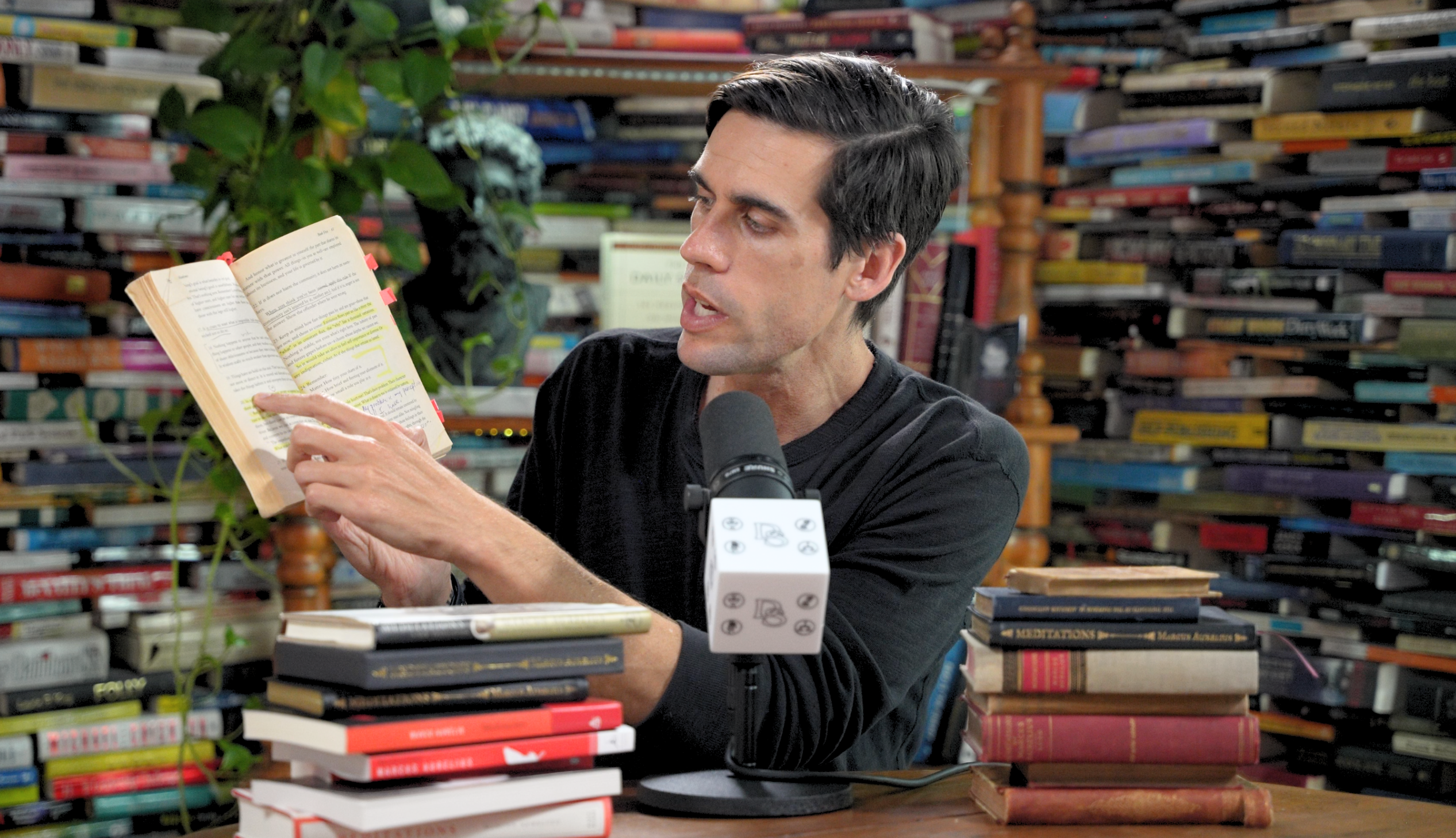 Ryan Holiday reading a book aloud at his desk